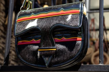 Colombian traditional leather satchel from the Antioquia Region called Carriel at the famous Comuna 13 in Medellin clipart