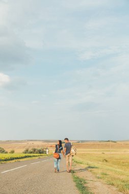 genç adam ve kız otostop yaparak. Yukarı başparmak. Kavram - macera, özgür, özgürlük. Kopya alanı