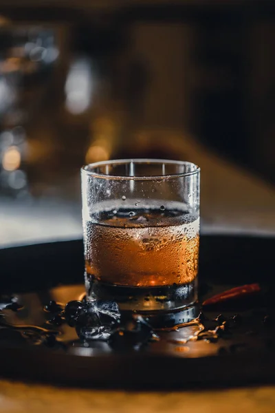 Refreshing soft drink. Cola and ice in the glass. Water droplets on the glass.