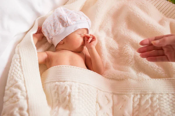 newborn boy covers his nose and mouth with his pen. child falls asleep