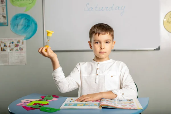 Boy reads an English textbook in class. Concept - children learn a foreign language. — Stock Image Boy Reads English Textbook Class Concept Children Learn Foreign Language Royalty Free Stock Images