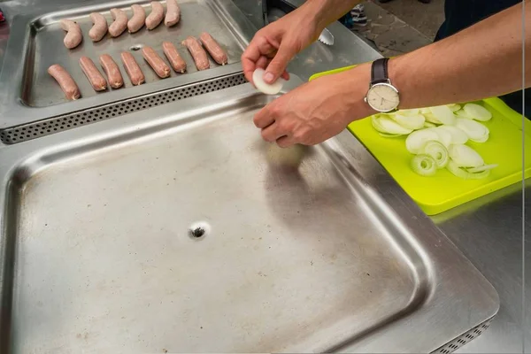 Setting up the barbecue with sausages and onions in Australia