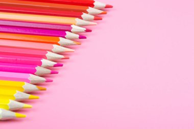 kırmızı bir arka plan üzerinde renkli kalemler