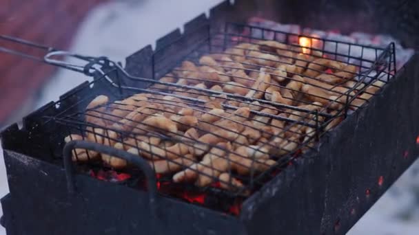 Барбекю - Смажені ковбаски смажать і копчують на вугільних грилях. Сосиски в натуральній оболонці. Смачні соковиті ковбаски смажать на вогні. Майже приготовані ковбаски на грилі — стокове відео