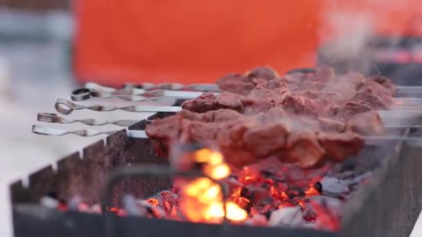 Carne de grătar pe frigărui, carne frumos prăjită pe grătar. O carne de porc pe cărbuni iarna. Gătitul shashlik pe mangal la exterior — Videoclip de stoc