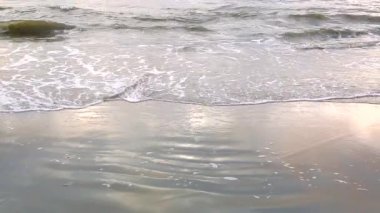 Dalga kıyıya, su güneş parlar yakın geliyor. Dalga deniz tarafından beyaz kum sahil güzel yıkanır. Arka plan veya doku