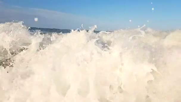 スローモーション、クローズ アップ、波はビーチに向かって移動、岸に向かって移動します。波の滴が上り坂にずきずきします。岸に近い海の波の動きが遅い — ストック動画