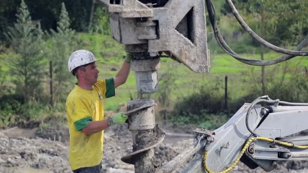 Bohrmaschine, die sich darauf vorbereitet, ein Loch im Boden zu bilden. — Stockvideo