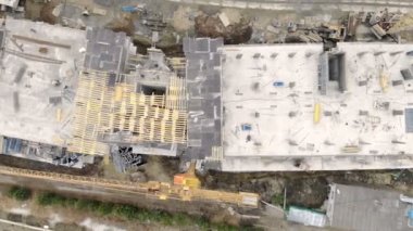 Yüksek katlı bina, bir dron ile üstten görünüm inşaatı. İşçiler bir ev inşa. Panorama inşaat alanının üstünden