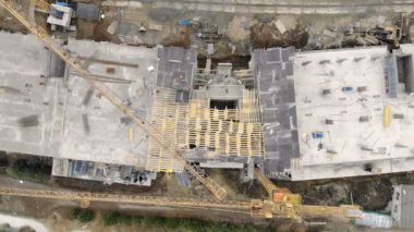 Yüksek katlı bina, bir dron ile üstten görünüm inşaatı. İşçiler bir ev inşa. Panorama inşaat alanının üstünden