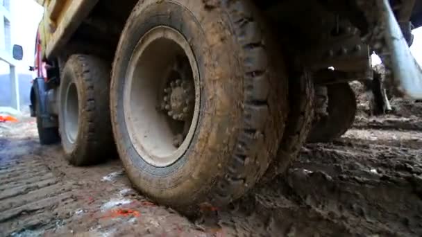 Close-up de rodas de caminhão que andam no pântano. Movimento lento. Condições de construção complexas. Filmado por lente de grande ângulo . — Vídeo de Stock