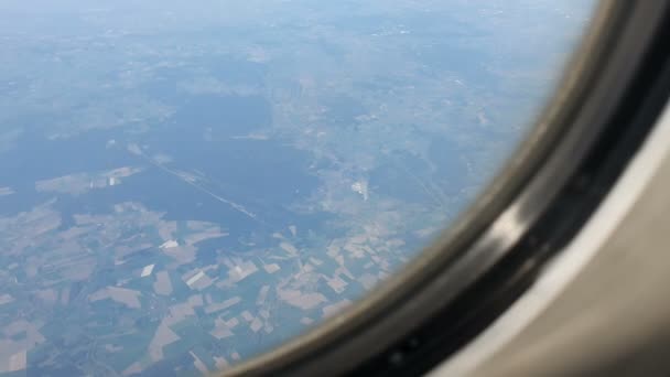 Vue par la fenêtre de l'avion. L'aile de l'avion contre le ciel bleu et les nuages blancs. Contexte — Video