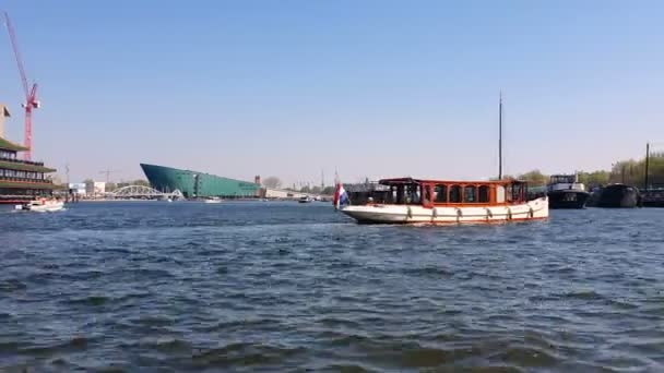 Amsterdam, Netherlands. 25.04.2019. Excursion ship Amsterdam white brown, swims without tourists — Stock Video