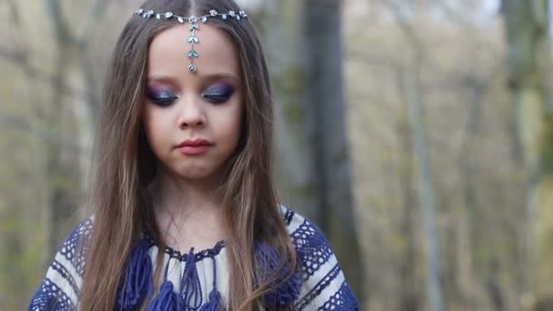 Close-up of the childs face. Little girl looking down and into the camera — Stock Video