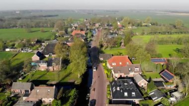 Hollanda'da havadan küçük güzel köy manzarası. Hollanda'da küçük bir köyün evlerinin ve sokaklarının çatıları üzerinde uçmak.