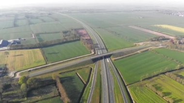 Hava görünümü Hollanda 'nın büyük şehirleri bağlayan karayolu yakınında uçan. Otobanda araçların hareketi.