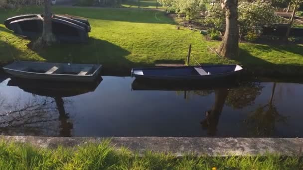 Eine kleine Bootsstation in einem kleinen Dorf. kleine Boote, die auf dem Steg stehen. Boote durch die Kanäle Hollands zu bewegen — Stockvideo