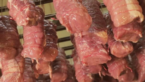 Morceaux de viande crue attachés au fil alimentaire, qui sont préparés pour la cuisson dans des fours industriels — Video