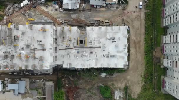 Aerial view of the construction site, and the construction crane from the top. Panorama of the construction site — Stock Video