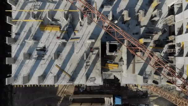 Aerial view of the construction site, and the construction crane from the top. Panorama of the construction site — Stock Video