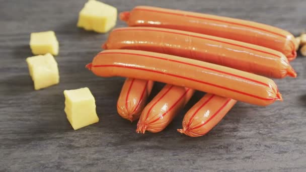 Sausages or sausages lie together with slices of cheese and nuts — Stock Video