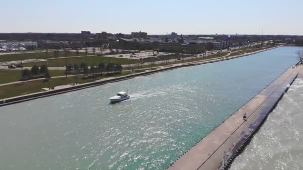 Aerial view fishing boat sails in the river canal. White boat floats on the river in the open sea on a sunny day. — Stock Video