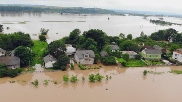 People who are in a flooded house by a river that overflowed after rain floods. Ecological catastrophe and flooded village and houses — Stock Video