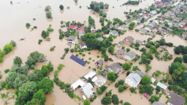 Aerial View from above on the flooded houses and the city. Flood after floods from the mountains. The houses are flooded with dirty water of the flooded river — Stock Video