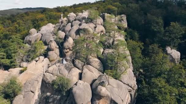 Pareja de boda en roca de montaña de dron. Vista aérea Felices recién casados enamorados abrazándose de pie en la cima de la montaña. — Vídeo de stock