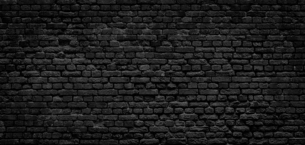 Old black brick wall panorama background. — Stock Photo, Image