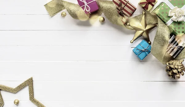 Christmas border made of christmas gifts and gold ribbon — Stock Photo, Image