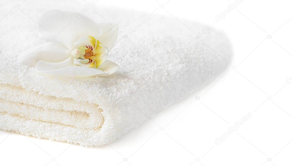 White towel with Orchid flower on white background