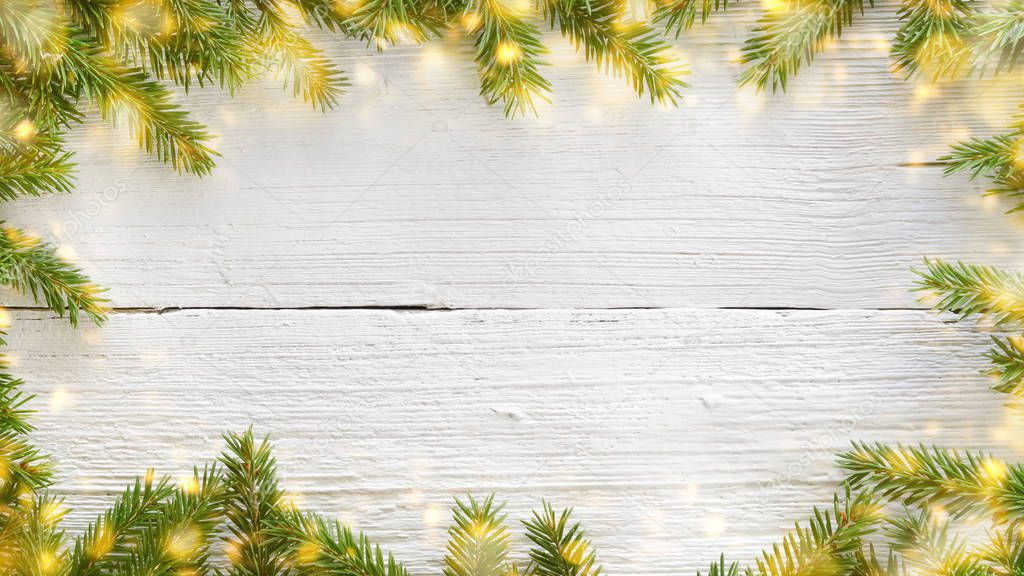 Christmas and New Year white wooden background with fir branches and lights