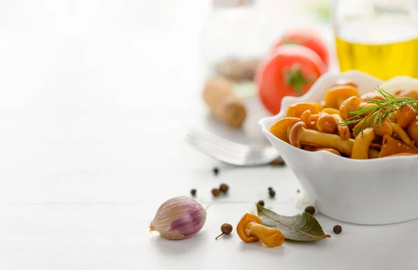 Marinated mushrooms in a bowl on the white wooden background. — Stock Image Marinated mushrooms in a bowl on the white wooden background. Stock Image