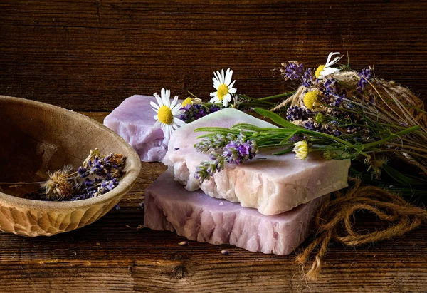 Handmade Soap with lavender and chamomile flowers on rustic wooden table. — Stock Photo, Image