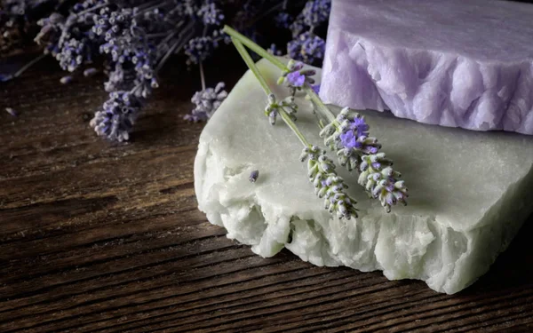 Handmade Soap with lavender flowers on wooden board.