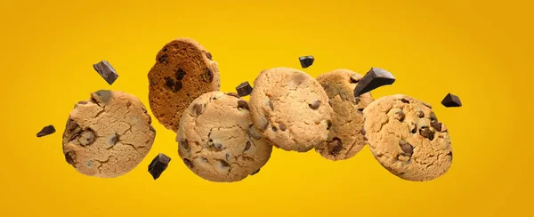 Chocolate chip cookies with pieces of chocolate Flying on yellow background. — Stock Photo, Image