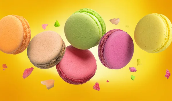 Colorful Macaroon sweet bakery on yellow background.