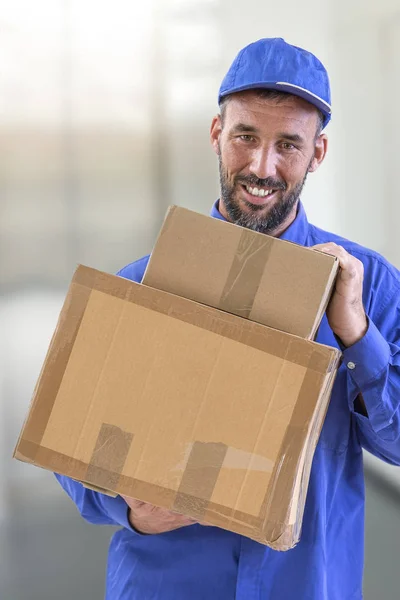 Box delivery. Delivery guy holding big parcel and smiling