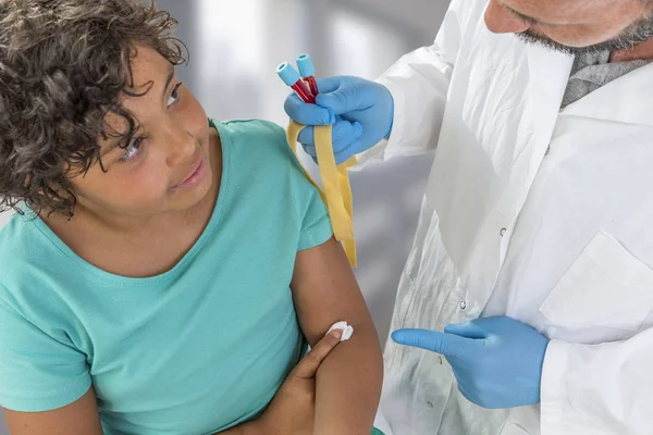 Blood Sample. Male Nurse taking blood sample from patient at the doctors office — Stock Photo, Image