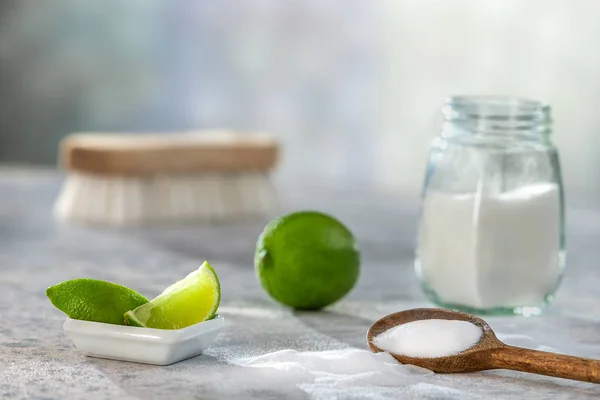 Natural cleaner. Vinegar, baking soda, salt, lemon.homemade grey wooden background