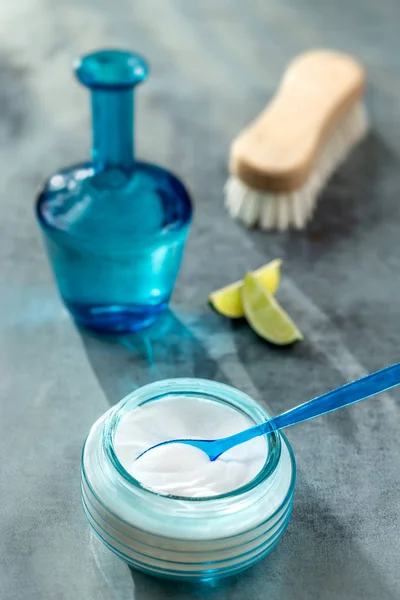 Composition withspoon of sodium bicarbonate vinegar and cleaning supplies on table. Space for text — Stock Photo, Image