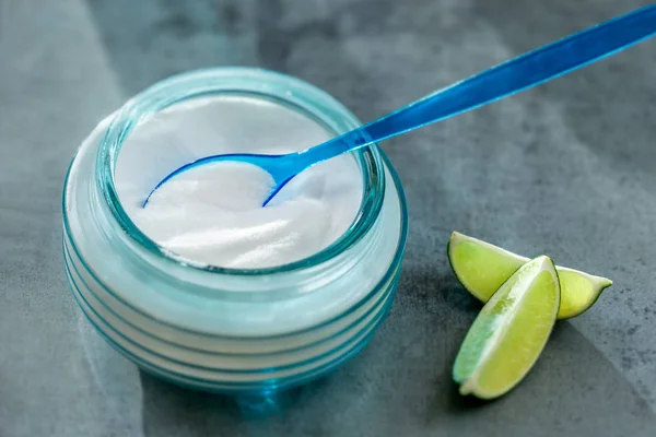 Composition withspoon of sodium bicarbonate vinegar and cleaning supplies on table. Space for text — Stock Photo, Image