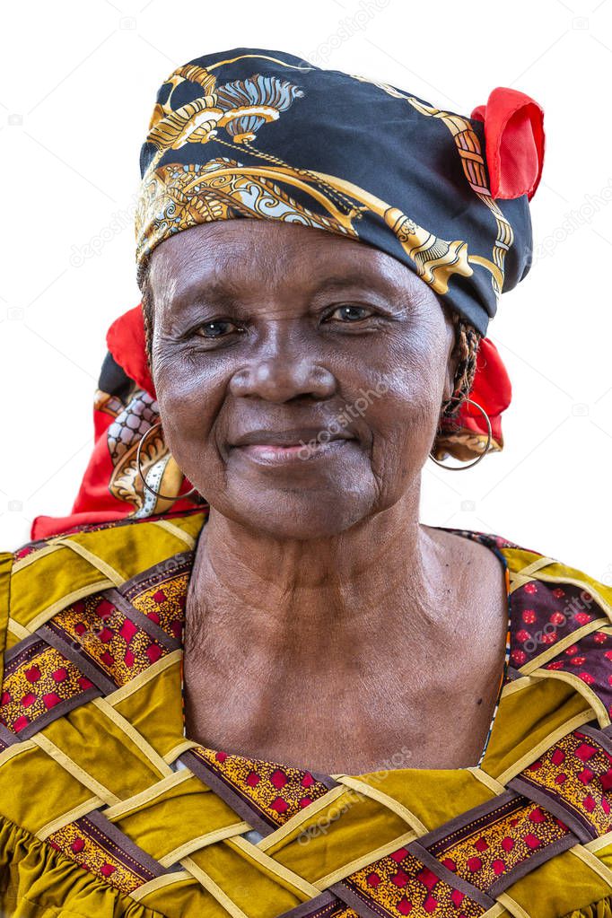 Portrait of African senior citizen woman in her 70- with a happy face in gold and brown dress