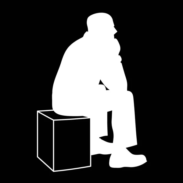 Hombre sentado en la caja. Silueta blanca aislada sobre fondo negro. Concepto. Ilustración vectorial del anciano sentado en un cubo poniendo codos en sus rodillas. Stencil. Minimalismo monocromático . — Vector de stock