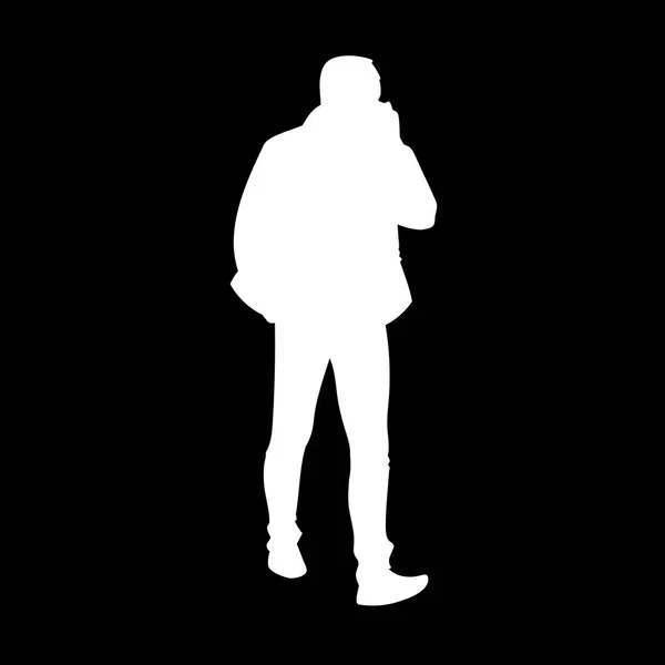 Adult man in jacket walking. White silhouette isolated on black background. Front view. Monochrome vector illustration of man taking a walk and talking on the phone. Concept. — Stock Vector