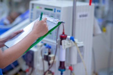 Uzman, sürekli renal yenileme terapi ekipmanlarını, enjeksiyon pompasını ve hemodiyaliz makinesini kontrol ediyor..