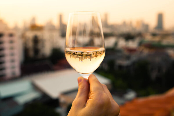 Young woman with wine in city 