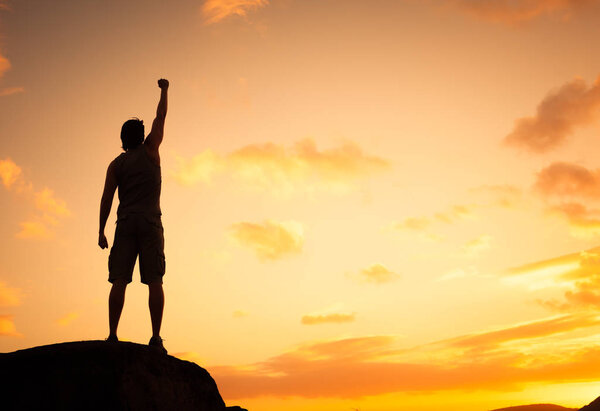Young man with hand up in mountains 