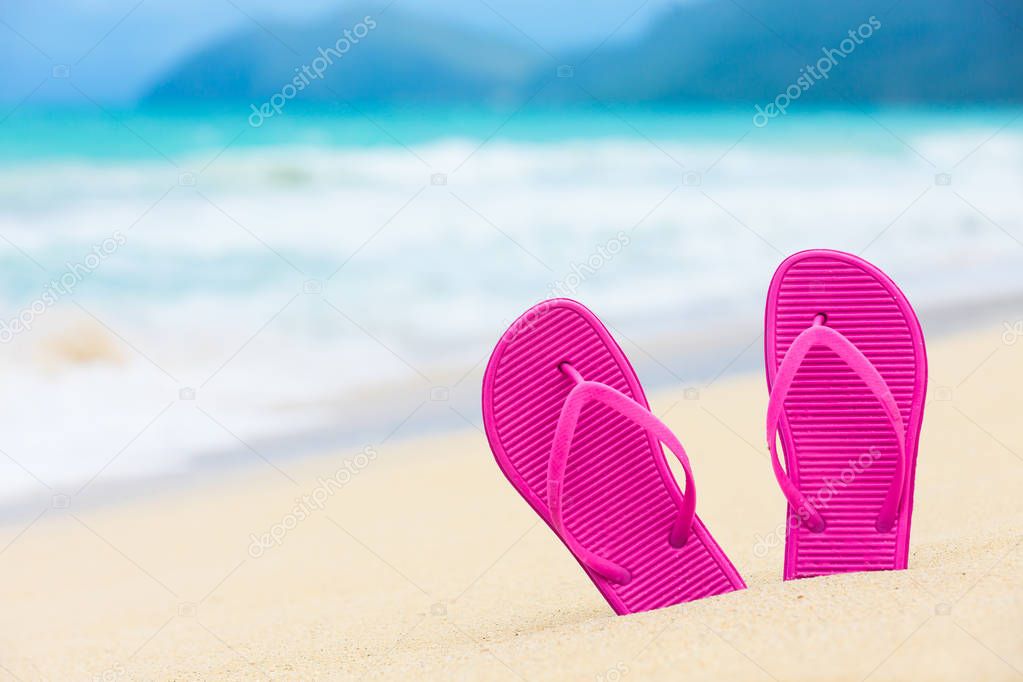 Pink slippers on the beach. Location Hawaii. 